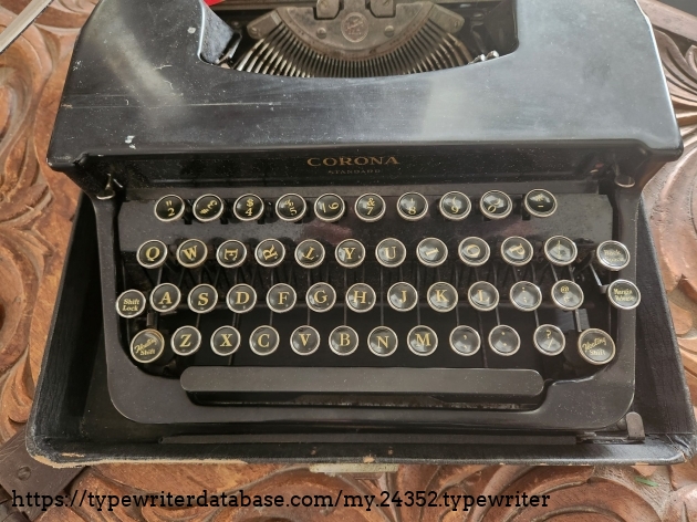 Focus onto the keyboard of a 1941 Smith-Corona Standard typewriter with several drunk key legends.