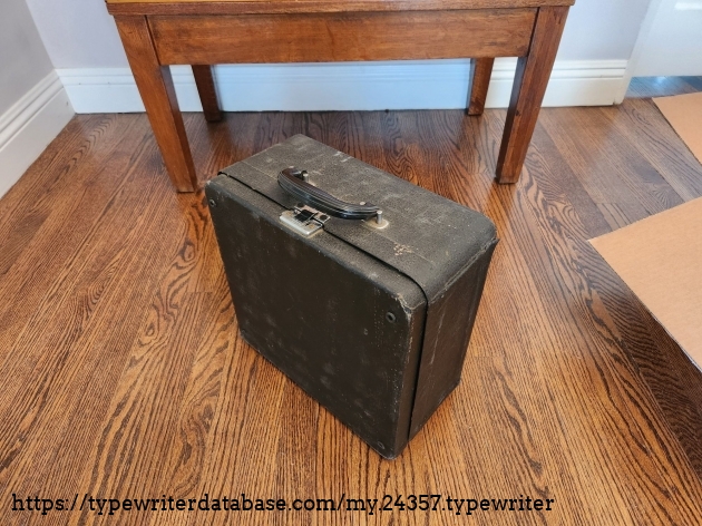 Angle down on a black dusty typewriter case for a 1939 Royal Aristocrat typewriter