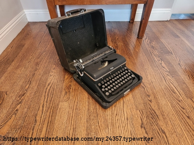 Unpacked and sitting on the floor we see an oblique view of the left side of a 1939 Royal Aristocrat typewriter