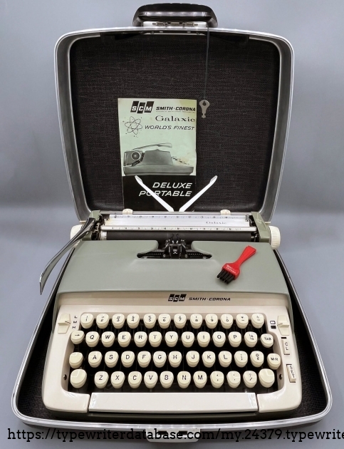 The original user manual, brush, and case key have stayed with the typewriter.