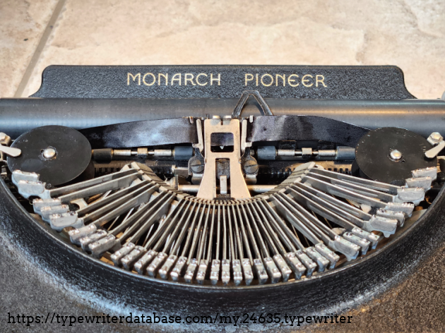 The logo on the paper table is the only place there is any sort of decal or marking on the body of this typewriter.