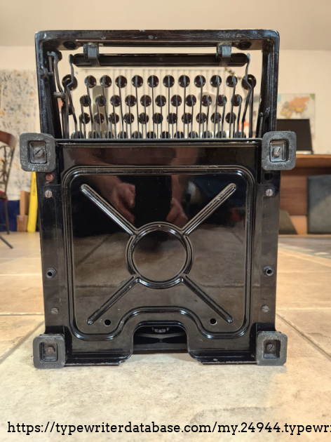 Note the screw holes about a third of the way up on either side of the bottom cover (about even with the lower part of the circle) that were used for mounting this to a desk so it wouldn't move during use.