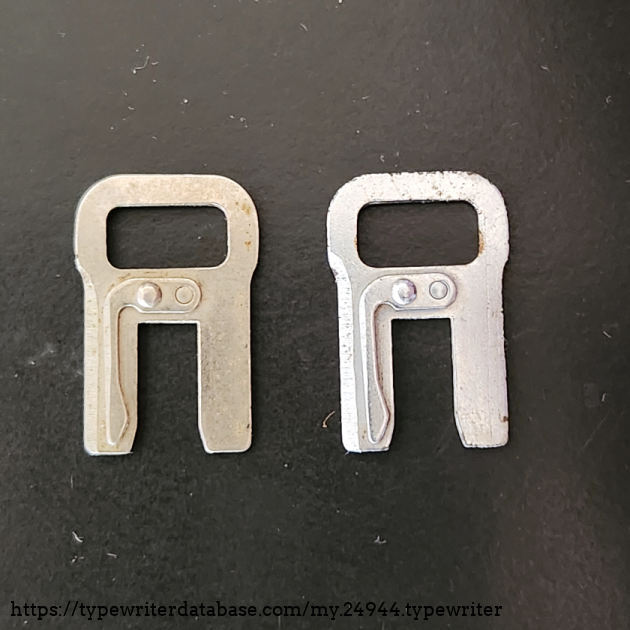 Two tab stops. note that one is steel and the other is chrome plated. The finish and style varied a bit over the course of production.