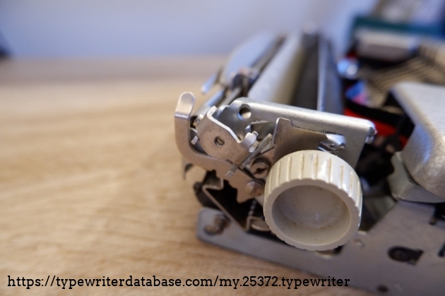 The carriage return lever bracket (with screw whole)