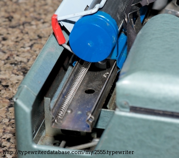 Instead of a typical watch-spring-and-band mechanism, this machine has something like a scaled-down version of a wooden screen door spring. But it does work...