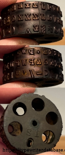 This is the early three-row "A Fitting" typewheel that came on the typewriter. It is not numbered, apart from the large mirrored "12" mold number on the base. I'm assuming it left the factory with this typewheel, which is interesting because it contains some non-matching characters on the keys: Z£ J§ X^ This is the early three-row "A Fitting" typewheel that came on the typewriter. It is not numbered, apart from the large mirrored "12" mold number on the base. I'm assuming it left the factory with this typewheel, which is interesting because it contains some non-matching characters on the keys: Z£ J§ X^