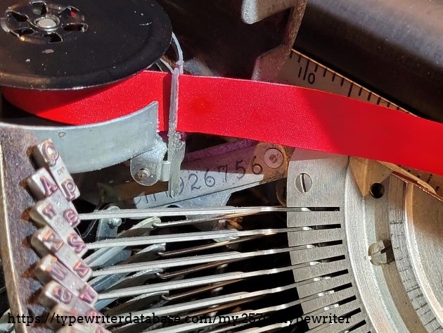 The serial number is hidden under the left ribbon spool. The serial number is hidden under the left ribbon spool.