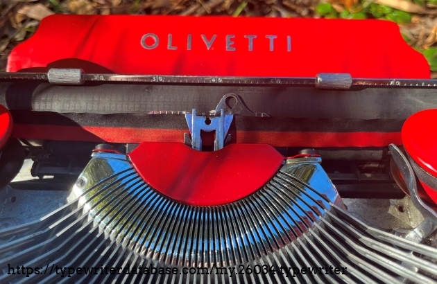 The OLIVETTI logo on the paper table is raised and the paint is perfectly filled around it.
