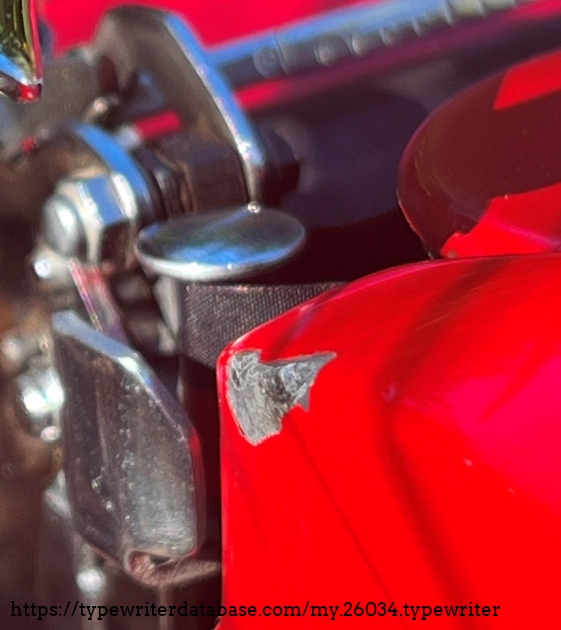 Quite a big chip on the ribbon spool cover where the return arm can hit. Ouch.