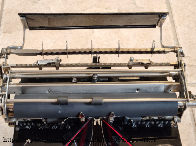 The logo-bearing paper table flips all the way back to allow access to the margin stops and tab rack.
