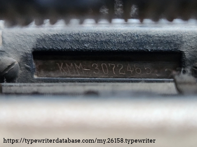Serial number in the right rear corner of the typewriter underneath the carriage.