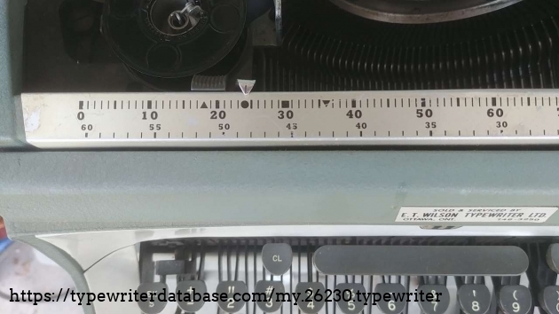 This margin scale is ordered from 0 to 130 from left to right, unlike the original model 5 standard.
The lower scale, smaller in size is used for centering text on the page.
The up arrow is to set margins for a 7" line, the dot is for a 6" long line, the square for a 5" line and, the down arrow is for a 4" line. This margin scale is ordered from 0 to 130 from left to right, unlike the original model 5 standard.
The lower scale, smaller in size is used for centering text on the page.
The up arrow is to set margins for a 7" line, the dot is for a 6" long line, the square for a 5" line and, the down arrow is for a 4" line.