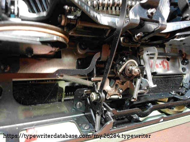 This machine's escapement is very simple, but I have never been able to understand what the little spring wrapped around it is for.  Such a mechanism is not present on my earlier 5 series typewriters.