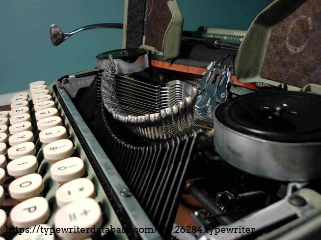 Can't say why the =/+ key rides higher than the rest.  seems to happen to some of these Silent Supers.  Original ribbon spools with silk ribbon!  (Dry, unfortunately.)