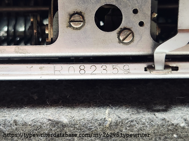 Serial R082359. This is printed twice on the typewriter. This one is found in the center of the back and visible by removing the back cover place.