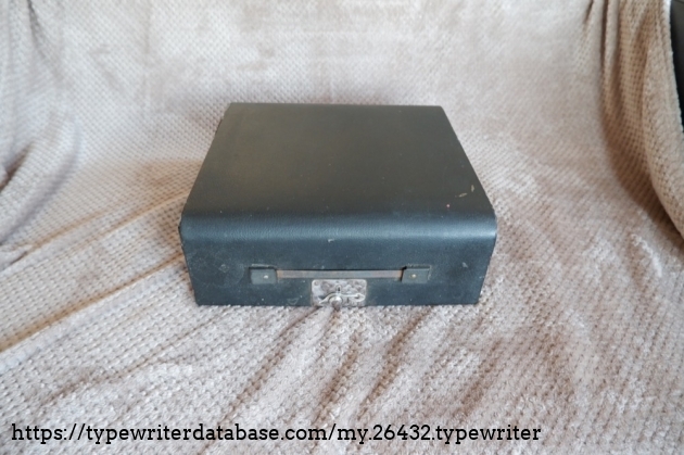 The case is solid wood, with a faux leather covering. The handle used to have leather (I think) but is now missing.