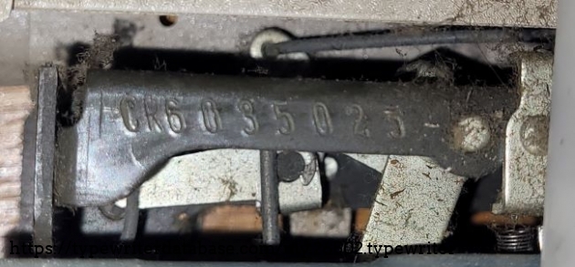 The serial number can be found underneath the left side of the platen.