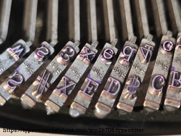 The mark on the slugs: "S/DP" - the DP stands for "Distinctive Pica." Apparently, this variation of Pica was made so that each character would take up the same amount of space. This may have been useful when filling in forms with blocks for each character? The capital "Q" is a good example of this - the tail is tucked underneath the letter like a little pedestal as opposed to projecting out the side.