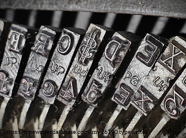 Type slug detail, focused on the Double Gothic "E" foundry mark.