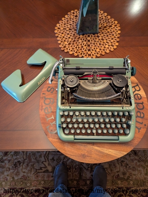 The ribbon cover design on this typewriter is really cool. There is a lever on the bottom right of the typewriter to release the front of the cover, and each hinge has a release so the cover can be removed easily.