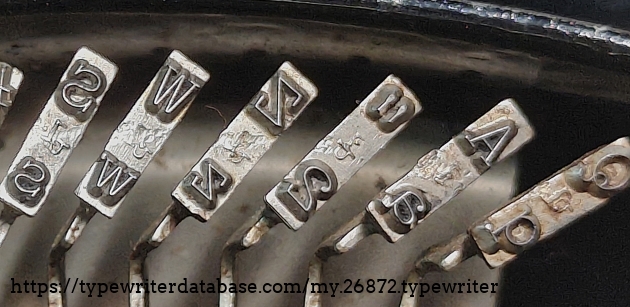 Type slug detail, left end of type basket.