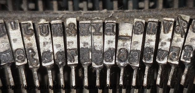 Type slug detail, middle range, showing the "P" foundry marks.  These type slugs need a cleaning!