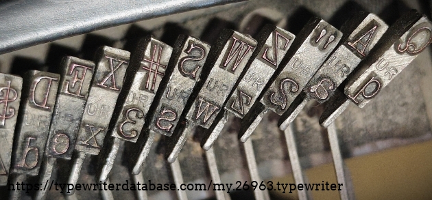 Type slug detail, left side, showing 10 CP "UR" typeface.