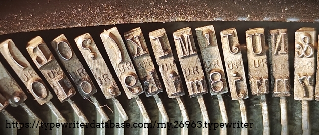 Type slug detail, center range, showing "UR" foundry marks.
