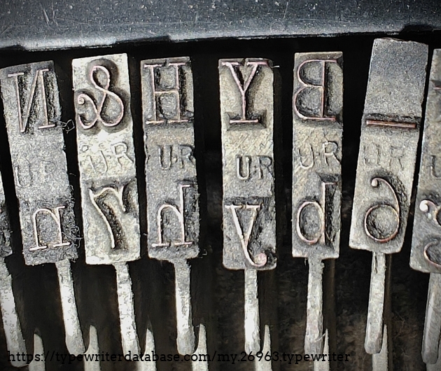 Type slug detail, focused center range, showing "UR" foundry marks.
