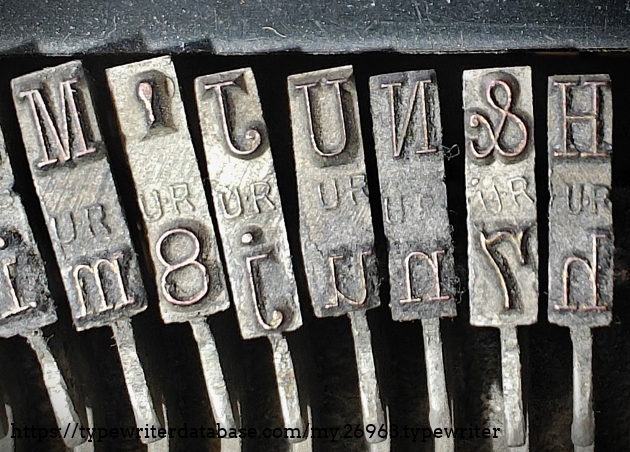 Type slug detail, focused center range, showing "UR" foundry marks.