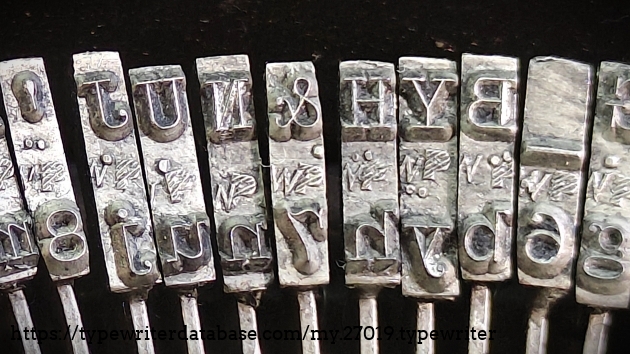 Type slug detail, middle range, showing hashed "P" foundry marks.