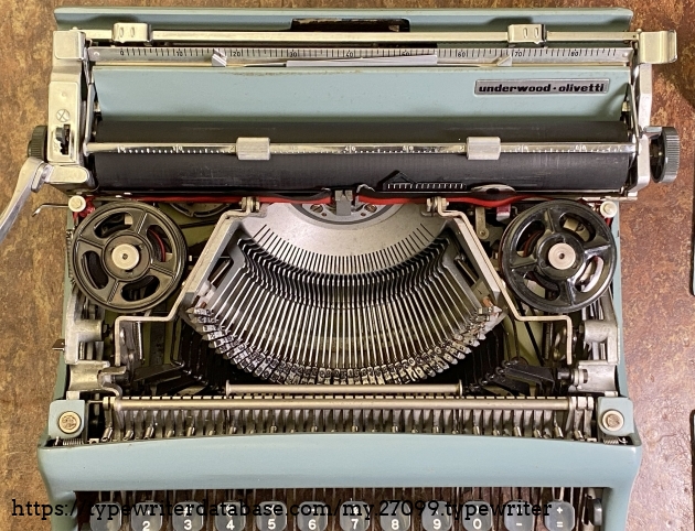 Cover removed to reveal innards: type bars and ribbon spools.