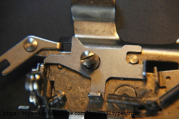 this is the slider that holds the carriage in place by placing its  bend up tooth at its right end into the gear rack.
 See the next picture for the part that comes on top of this...