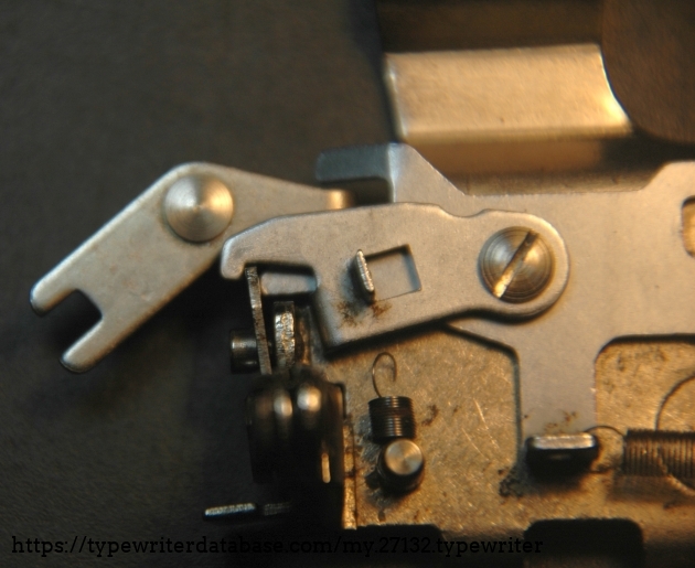 This part and its bend up tooth is pushed into the gear rack before the 'main dog' is taken out of the rack's way by a 'space command'