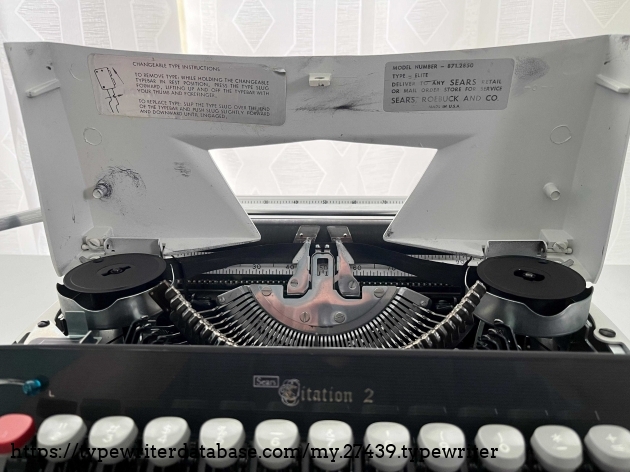 Spool cover, instructions for slug change, and Sears model number 871.2850 and elite size typeface.