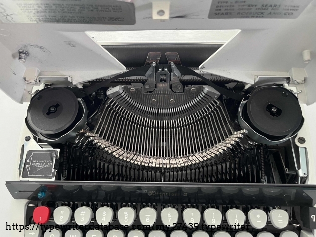 Ribbon spools and key slugs.  The lower left square is for storage of removable slugs.