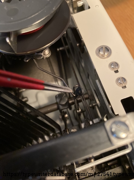 If you run the key tension up, you can unhook this ribbon mech spring here.