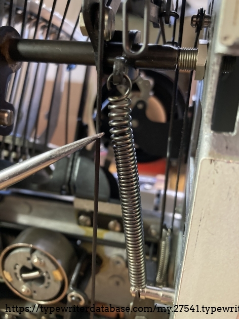 Taking a little tension off the segment spring. Be careful how much you spread this. Too much and it won't pull the segment down all the way.