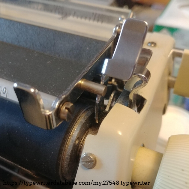 The paper release lever also pushes the paper bail away from the platen, rather that lifting it.  It makes it easier to thread in new paper, without touching the paper bail rollers.
