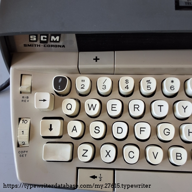 The ribbon reversing selector was moved to the keyboard from being under the cover in the previous series.

The half-spacing button is now left of the space bar.