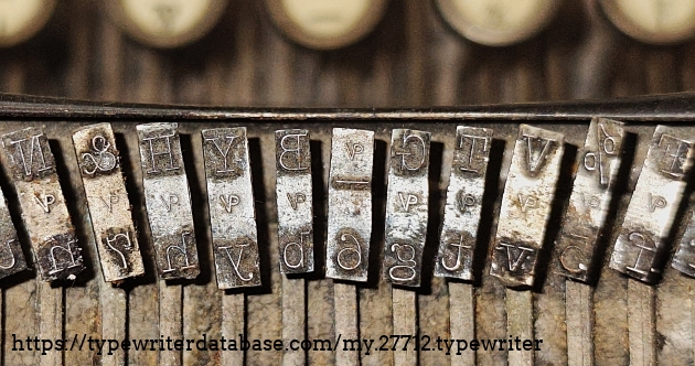 Type slug detail, showing very dirty type slugs, and "VP" foundry marks indicating "Victor Pica", I would think.