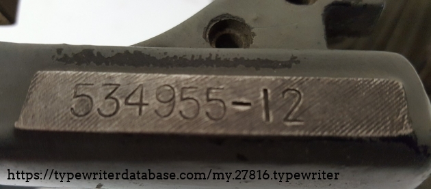 Serial number, with the machine currently being disassembled. The original black paint is visible beneath the peeling gray paint.