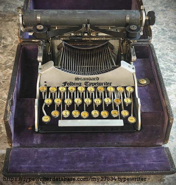 Typewriter in its case of purple velvet.  Ironically, my 1916 Corona 3 also came in a purple velvet case.