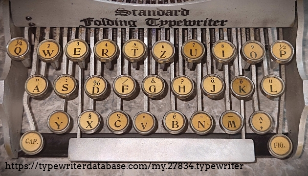 Keyboard closeup.  QWERTZ key arrangement.  With the various French and German diacritical marks included, it appears to me to be a Swiss layout.