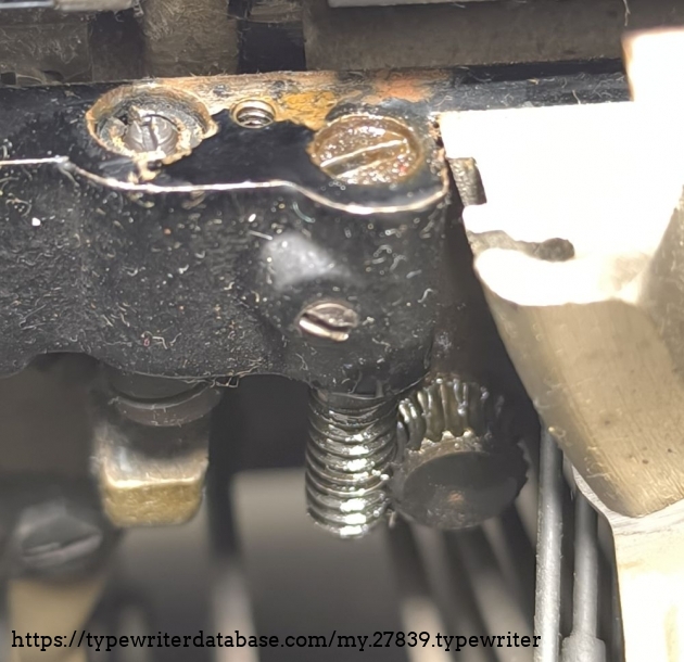 This mechanism serves to tension the spring that pulls the carriage.