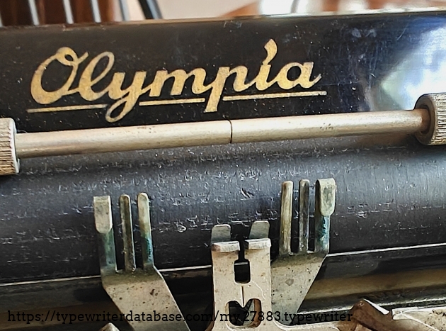 Olympia decal on paper table.