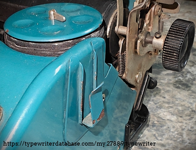 Spool cover and clip, right-hand of front.