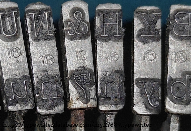 Type slug detail, showing the 1 for Pica and "Circled K" foundry mark.  Similar to Corona, Smith-Corona, and even Standard Folding.