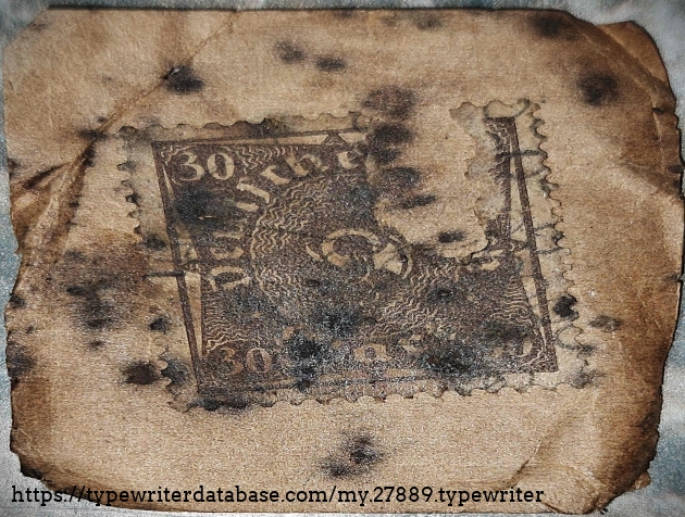 Underside of cleaning kit instructions card, showing the remains of a Weimar-era German 30 Mark postage stamp (circa 1922).