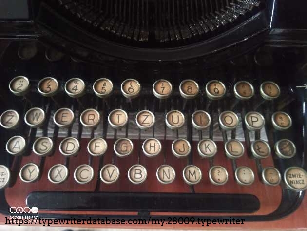 Mechanical defects: Missing the central type bar (letter "Z") and the last type bar on the far right (letter "Q").